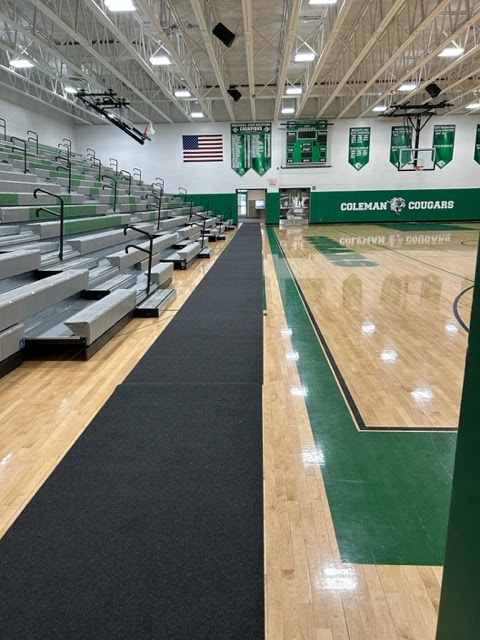 courtside runners protect the floor in basketball gym at Coleman High School