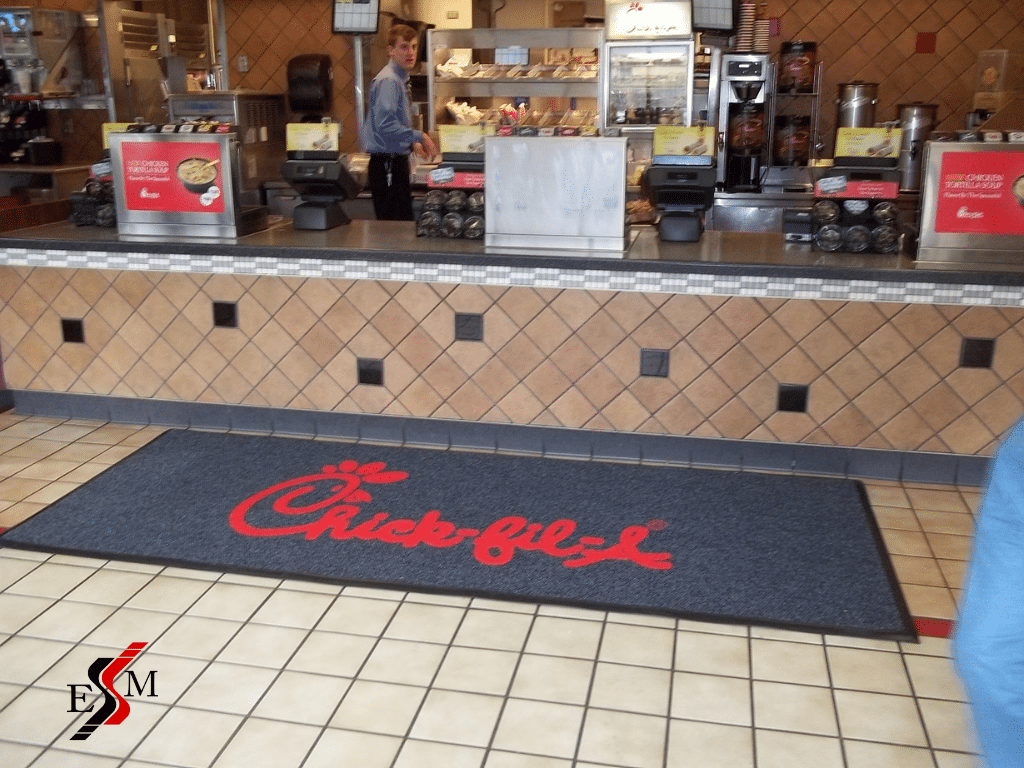 customizable floor mat with restaurant logo at cashier Chick-fil-a